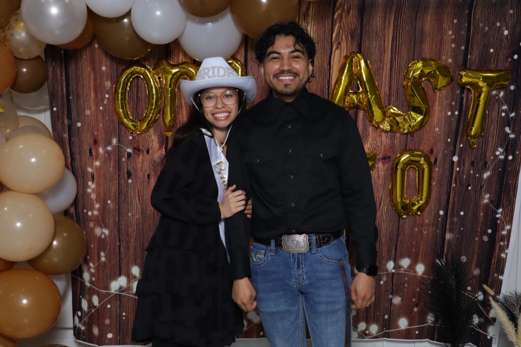 Bride and groom smiling together at a cowboy-themed bridal shower in Dallas.