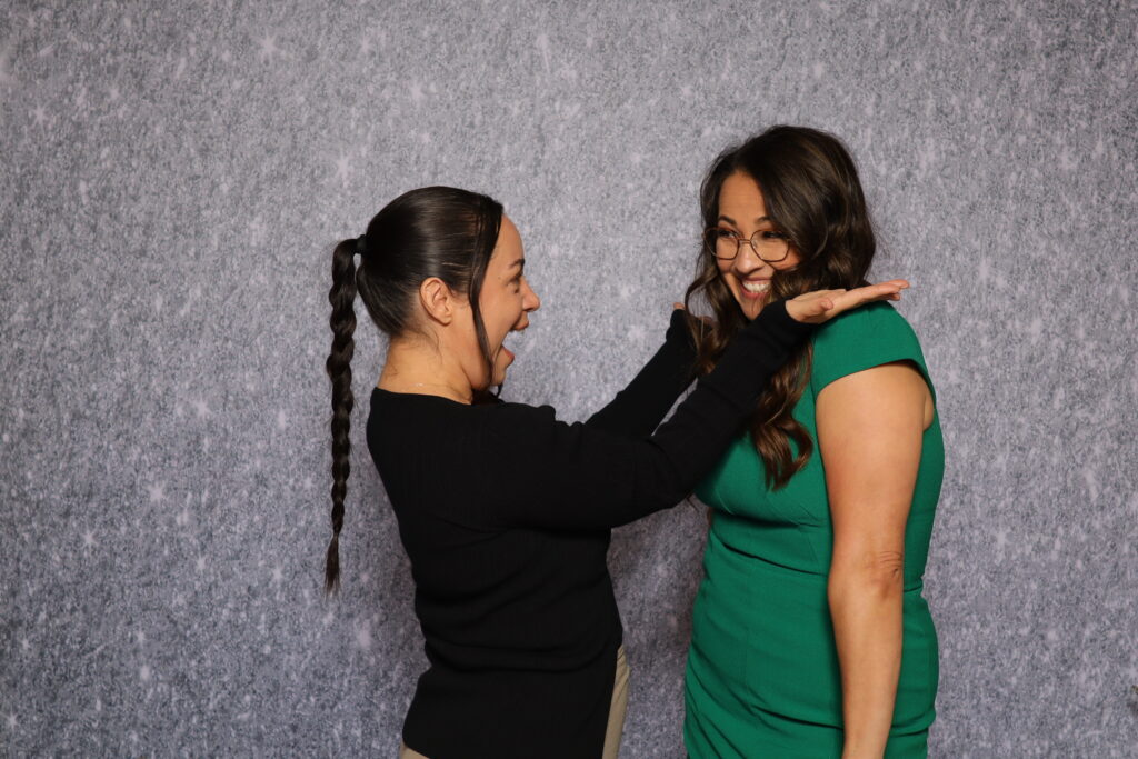 Friends laughing and capturing memories at a Dallas photo booth party.